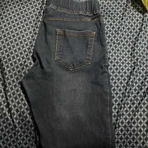 Blue jeans with rips in it. Has both front and back pockets. SIZE SMALL.